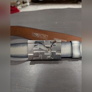 Puma golf belt with a silver-toned metal buckle featuring the Puma cat logo